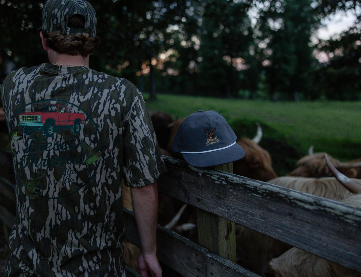 Diesel Threads camo shirt and Whitetail hat out on the farm